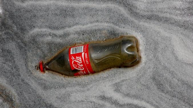 A Coke bottle on a beach in South Africa.