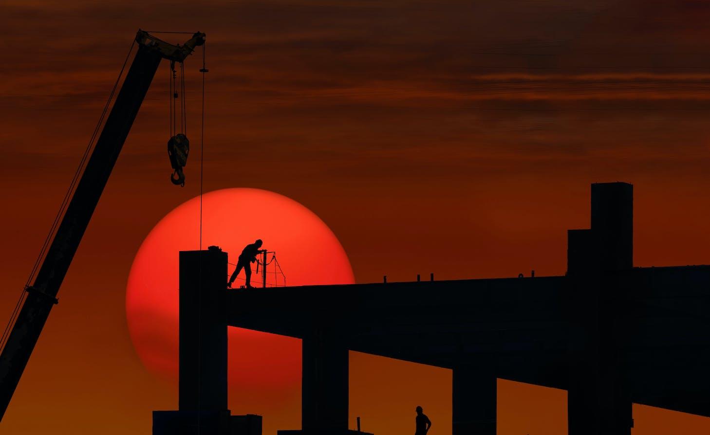 An unidentified construction site against a sunset.