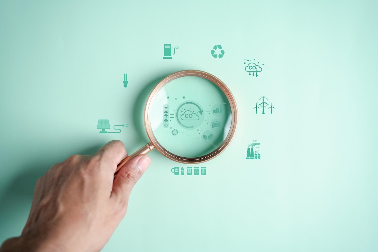 Magnifying glass focusing on sustainability icons