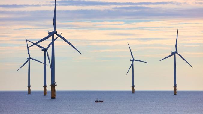 A photo of wind turbines in the ocean 