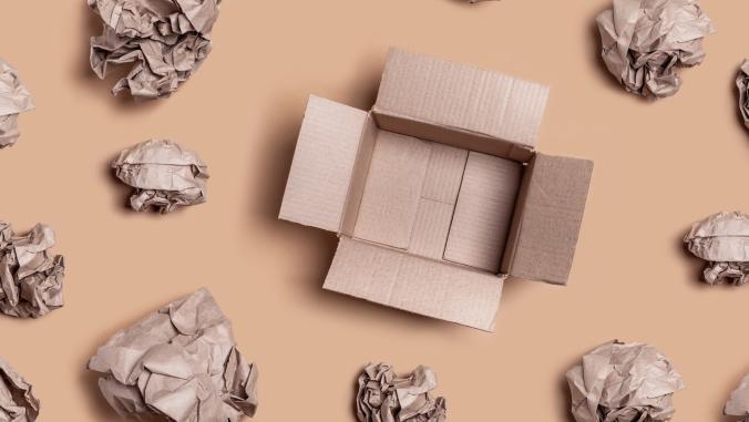 An open box surrounded by crumpled packing paper